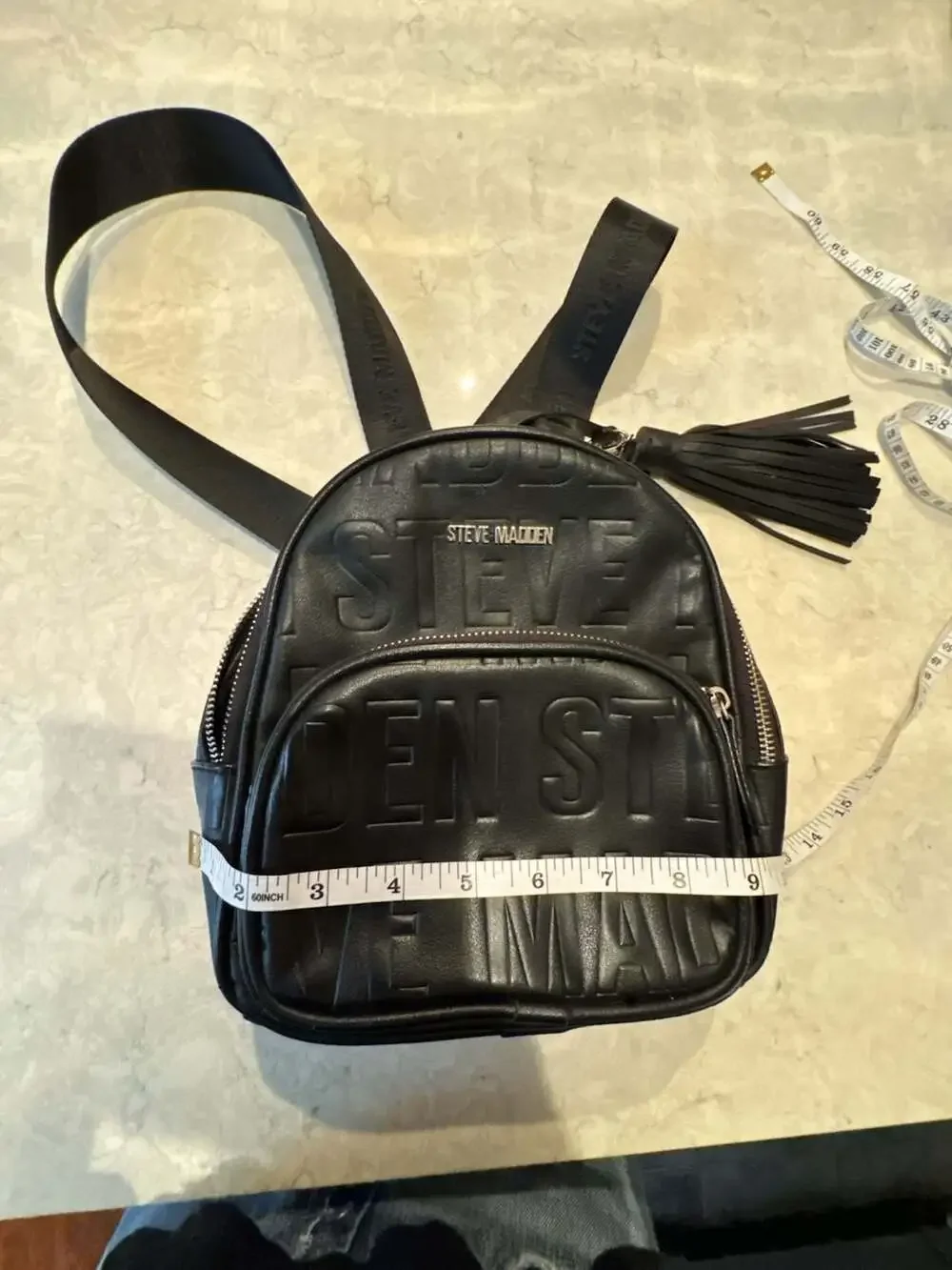 Steve Madden Black Mini Backpack Purse with Embossed Logo and Tassel